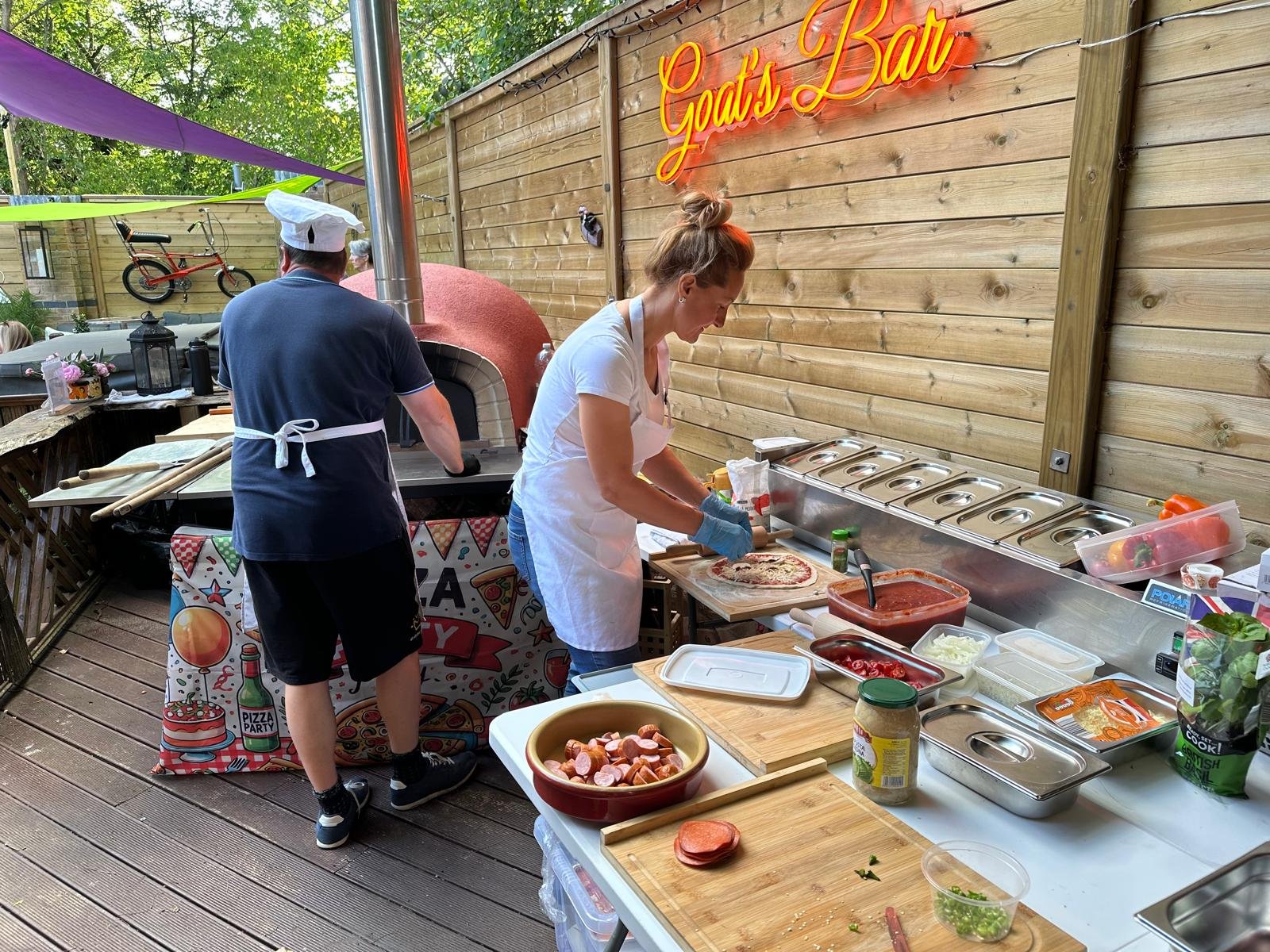 Pizza prep table with fresh toppings at Andy's 60th birthday