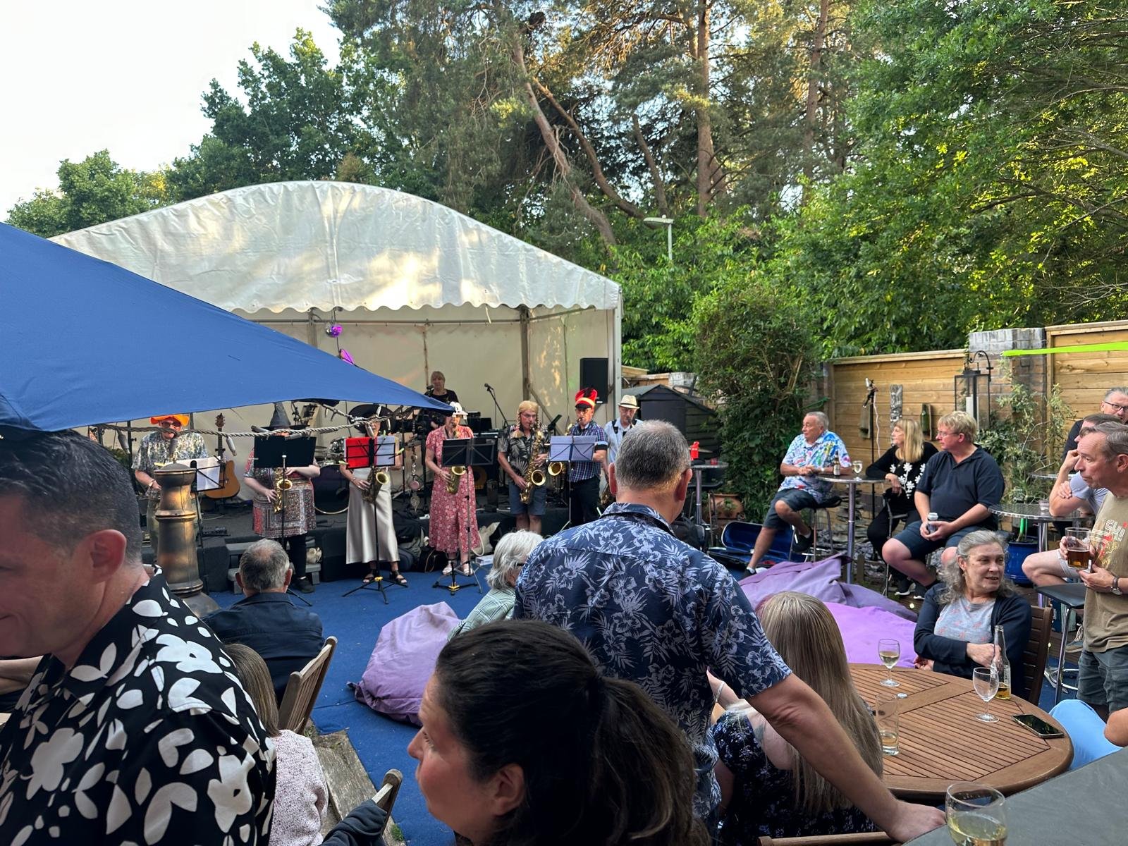 Crowd enjoying live music and pizza at the celebration