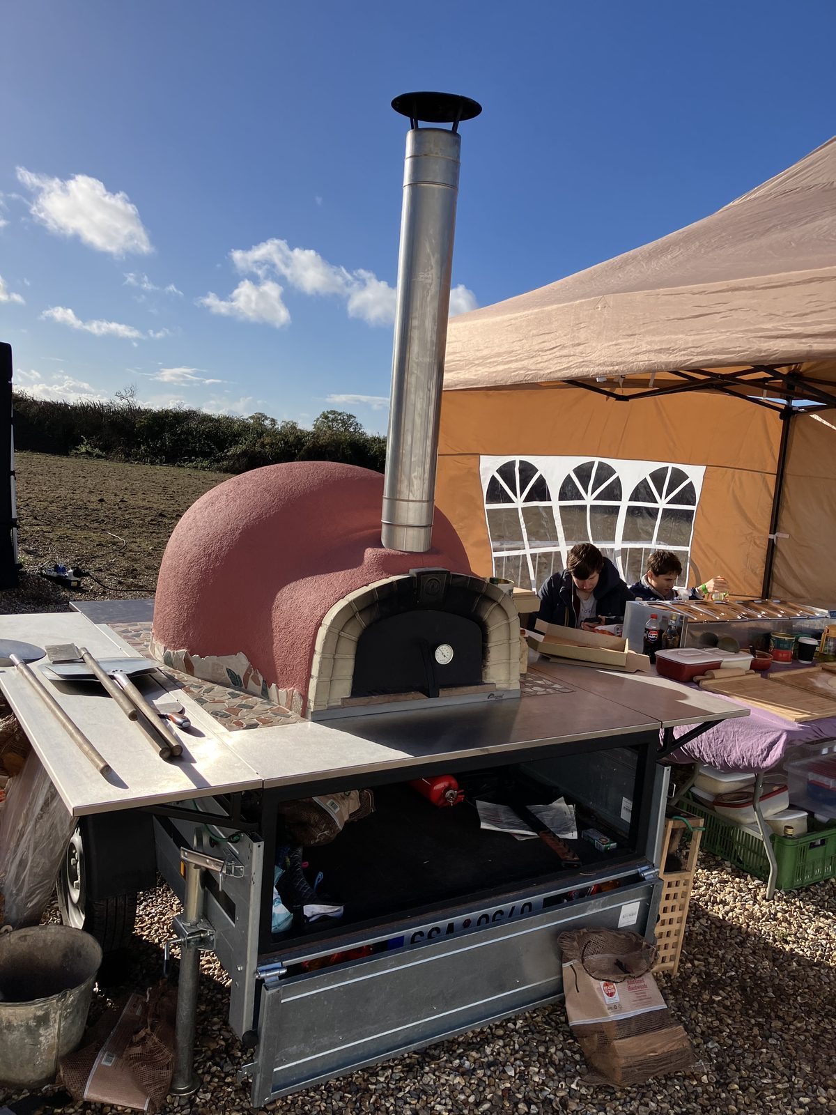 Full outdoor pizza catering setup with pink dome oven