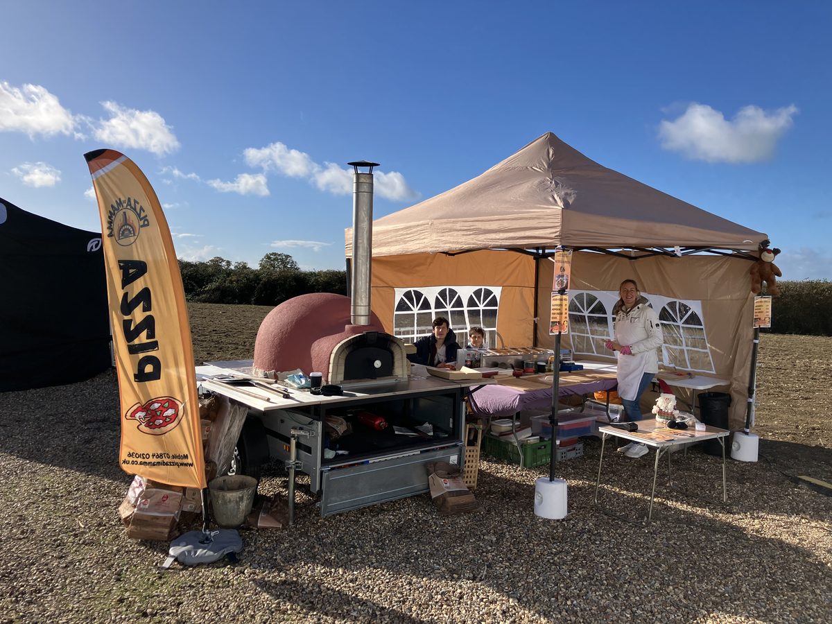 Serving fresh pizzas to customers at outdoor festival