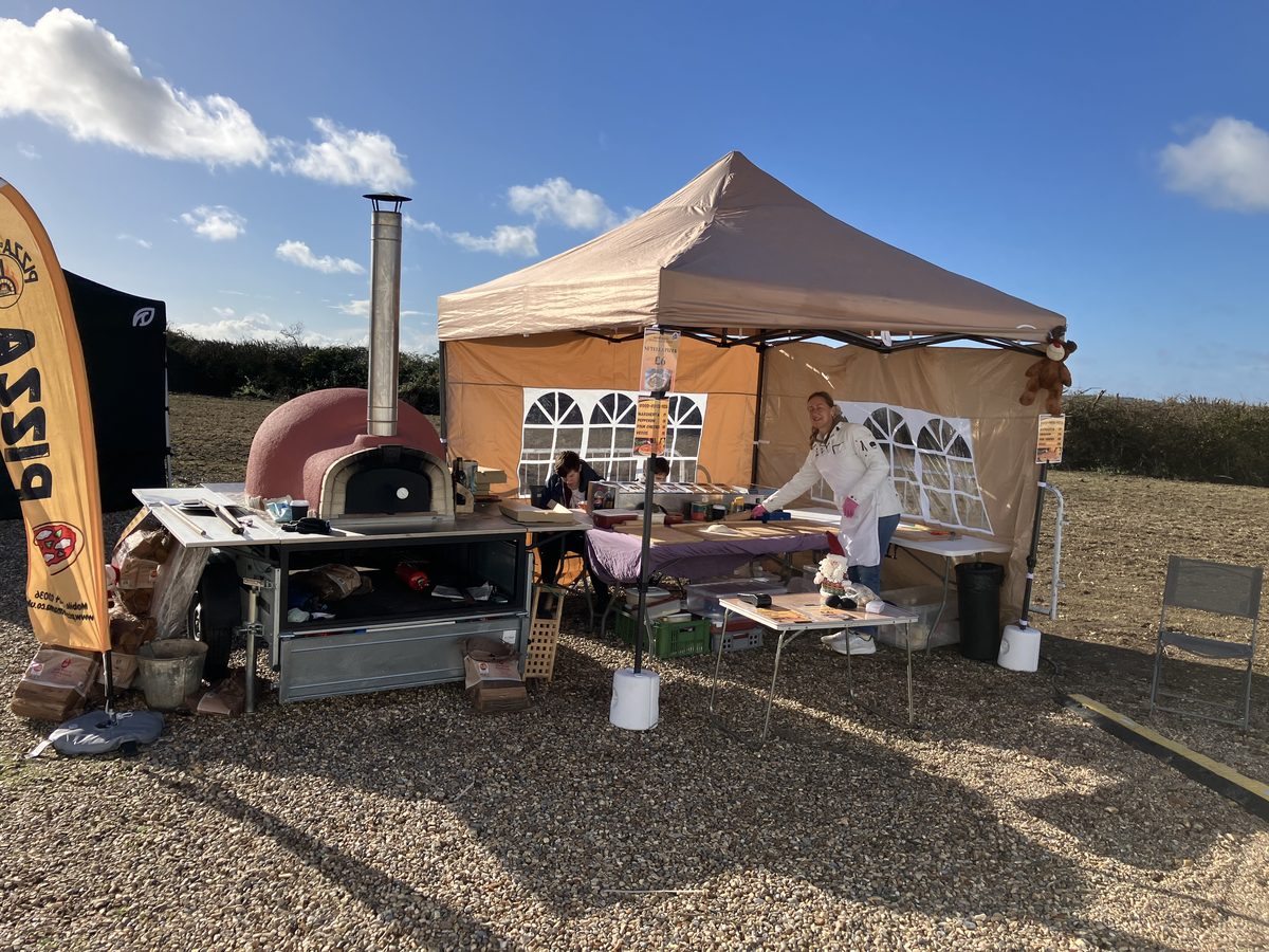 Pizza di Mamma wood-fired oven and tent setup at Christmas festival